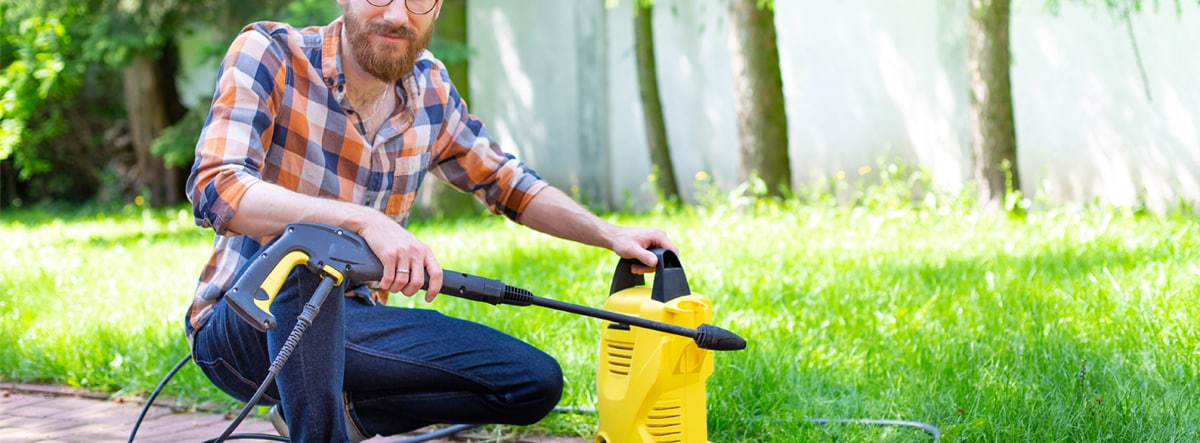 Consumer Using Electric Pressure Washer