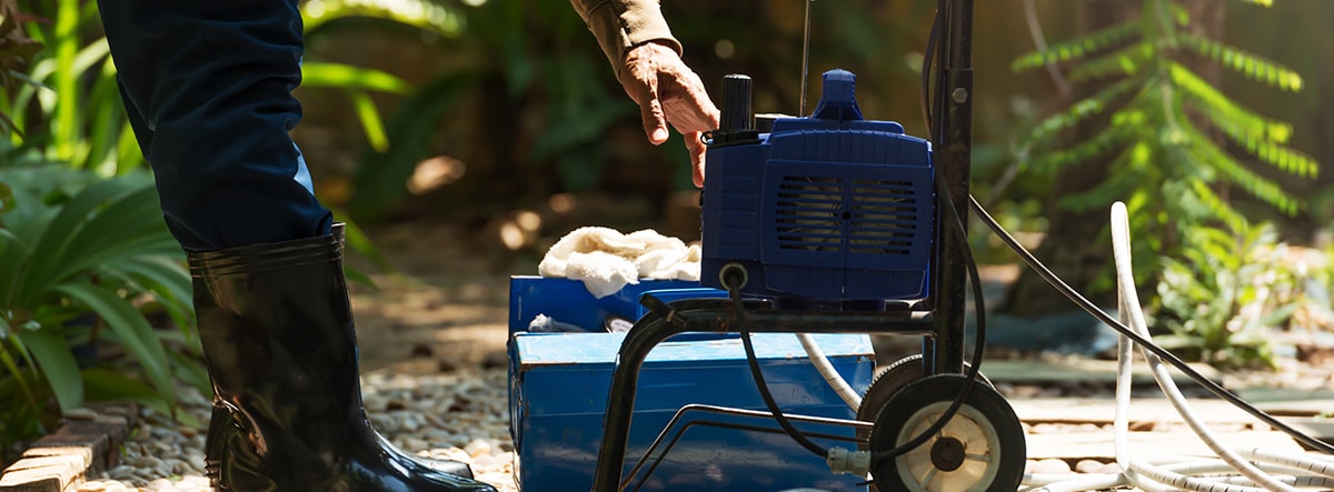 Man Maintaining Pressure Washer