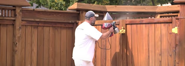 Contractor Using HVLP Sprayer on a Fence