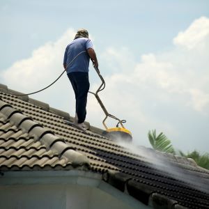 Man Cleaning Roof With Surface Cleaner