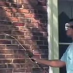 Man Sealing Brick Wall