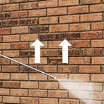 Using Pressure Washer to Wet Brick Wall